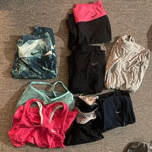 Bag of Nike gear 2 tank tops 4 long slim pants and 4 skinny leg capris